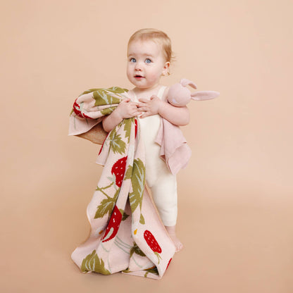 Baby holding The Blueberry Hill Strawberry Bunny organic baby blanket

