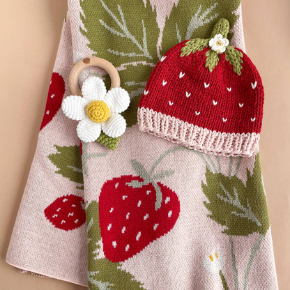 Strawberry knit baby hat and flower rattle on The Blueberry Hill Strawberry Bunny blanket