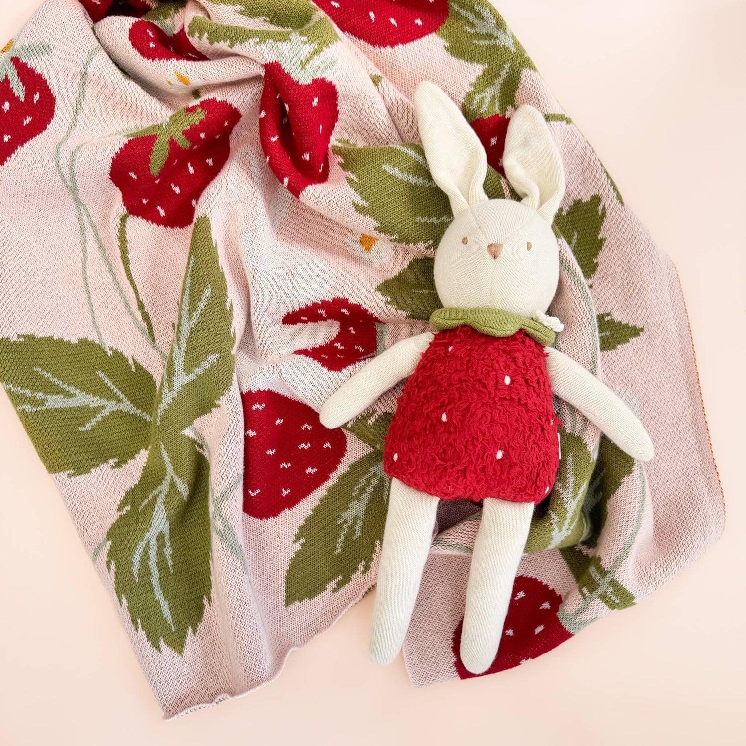 Bunny plush toy on The Blueberry Hill Strawberry Bunny blanket
