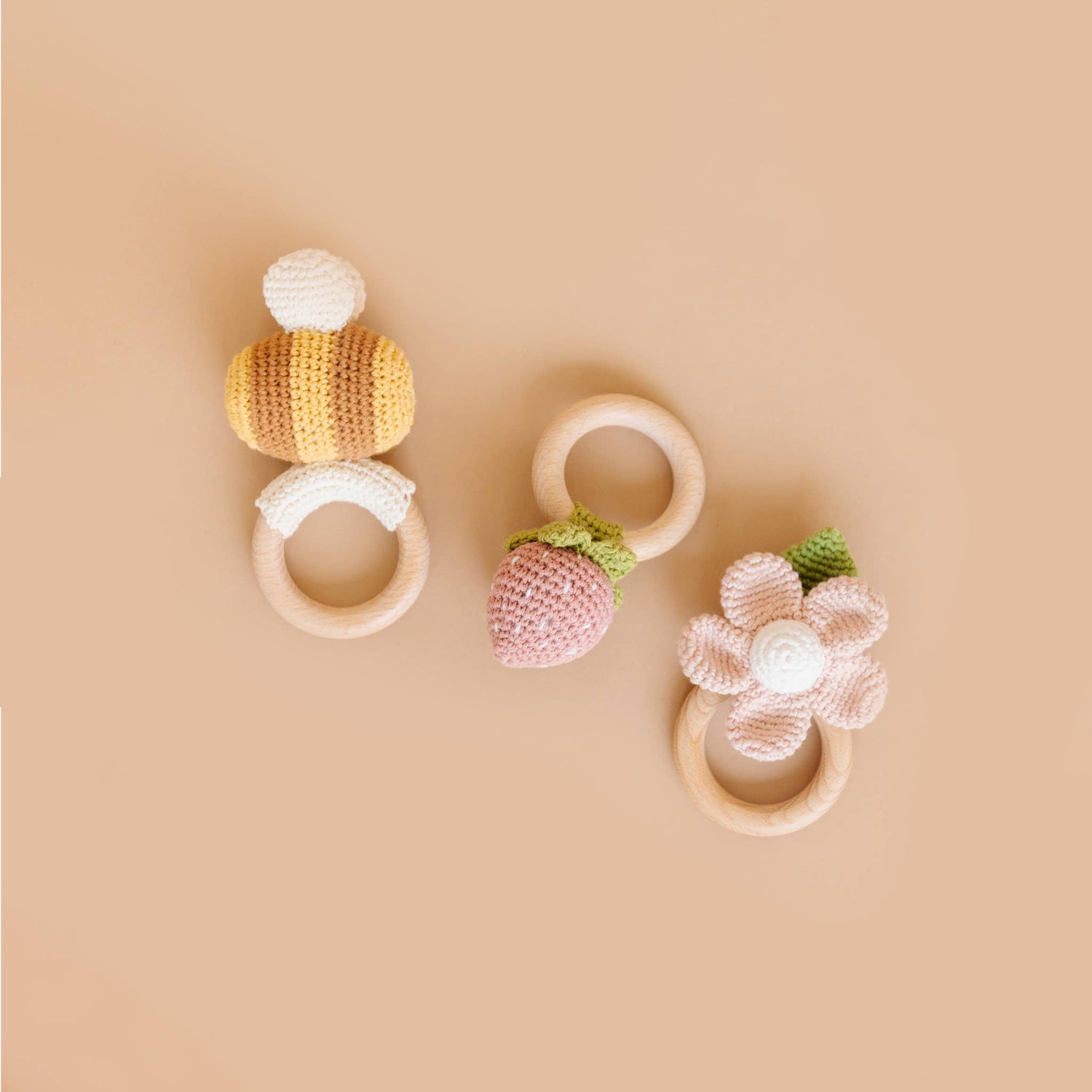The Blueberry Hill bee, strawberry, and flower crochet baby teethers
